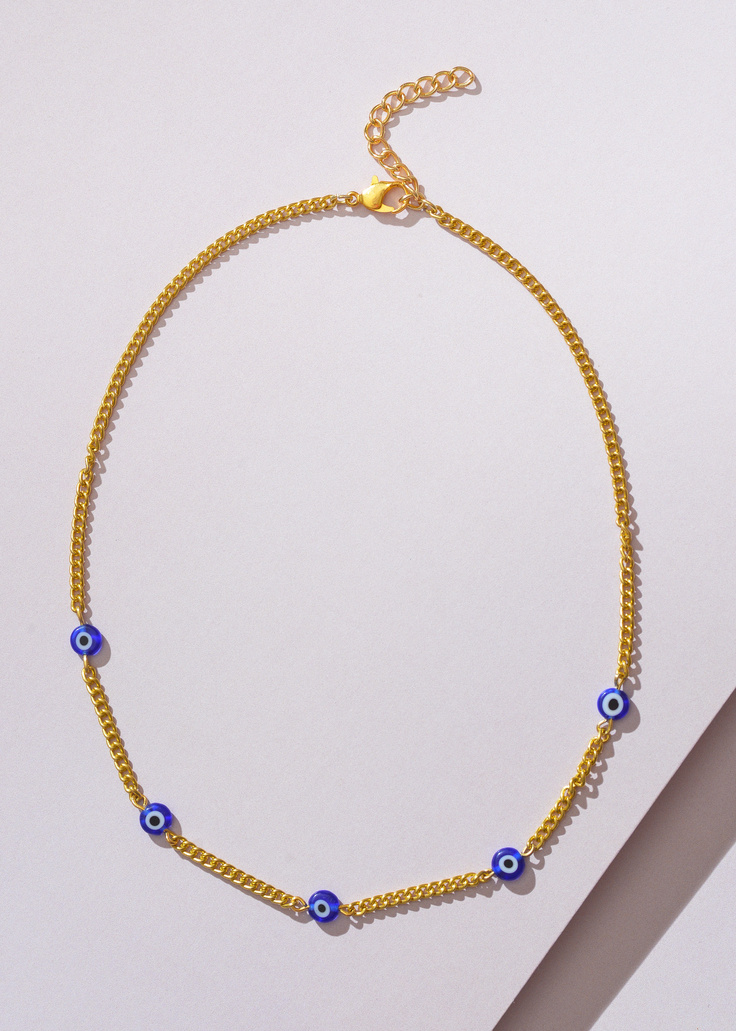 Gold Chain Necklace on White Surface